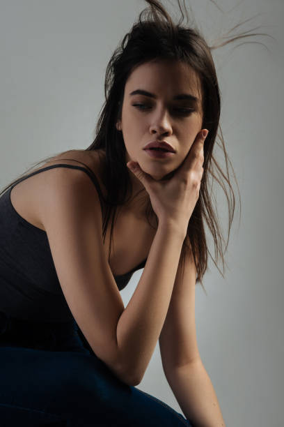 istock Lovely stern young lady thinking 906769622