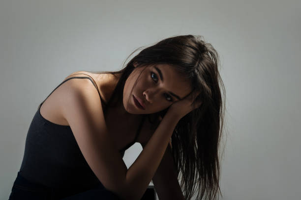 istock Sad woman sitting and thinking 906769698