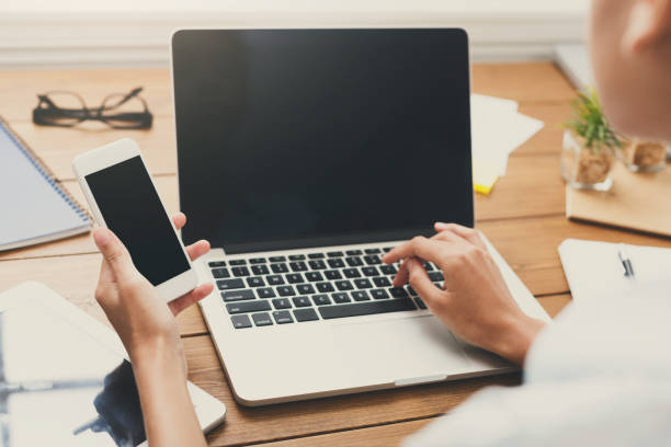 istock Closeup of the hands working on laptop with blank screen 906770240
