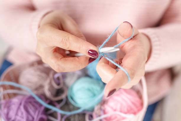 istock Female knitting colored yarn 906772508
