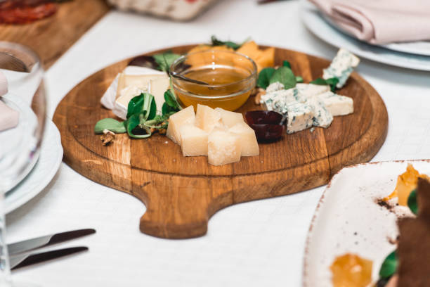 istock Mix cheese on wooden board with tomatos 906773290