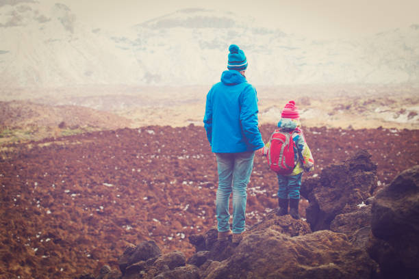 istock father and little daughter hiking in mountains 906774302
