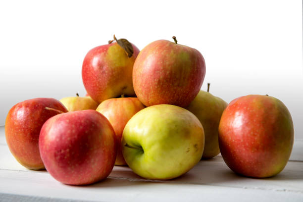 istock red and yellow apples on the white wooden table 906774542