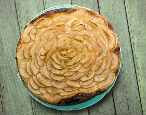 istock an apple pie on a green wooden table 906774556