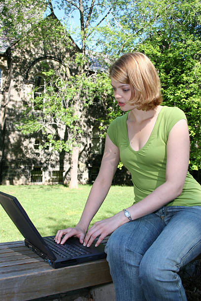 istock Young Female Working on Laptop in Park 90677749