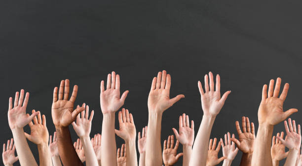 istock Close-up Of Raised Hands 906777504