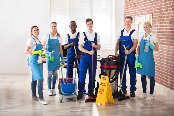 Portrait Of Diverse Janitors Portrait Of Happy Diverse Janitors In The Office With Cleaning Equipments housekeeping staff photos stock pictures, royalty-free photos & images