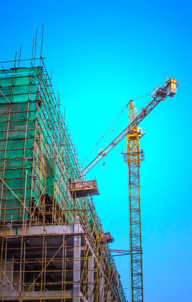 istock Crane tower is building tall building at construction site 906777600
