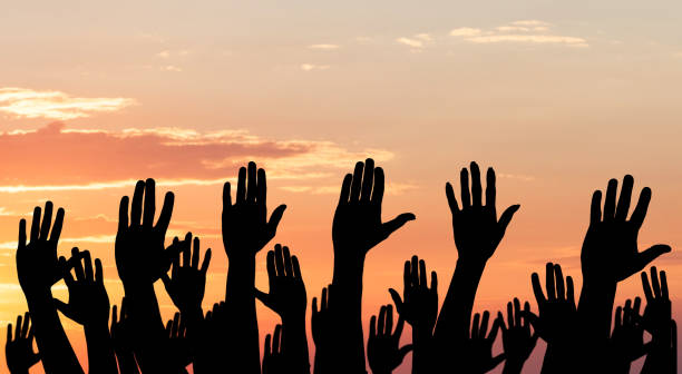 istock Silhouette Of Raised Hands 906777628
