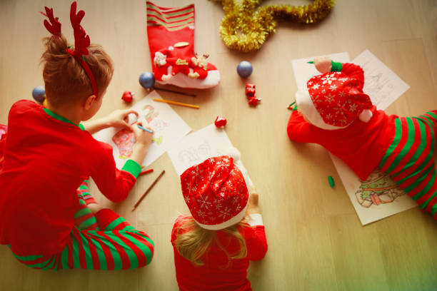 istock kids making Christmas crafts, family celebration 906777794