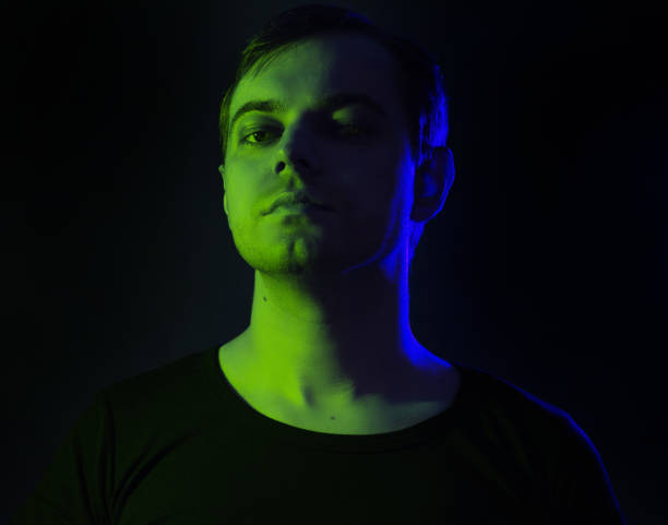 istock Portrait of a man with colored light. 906778480