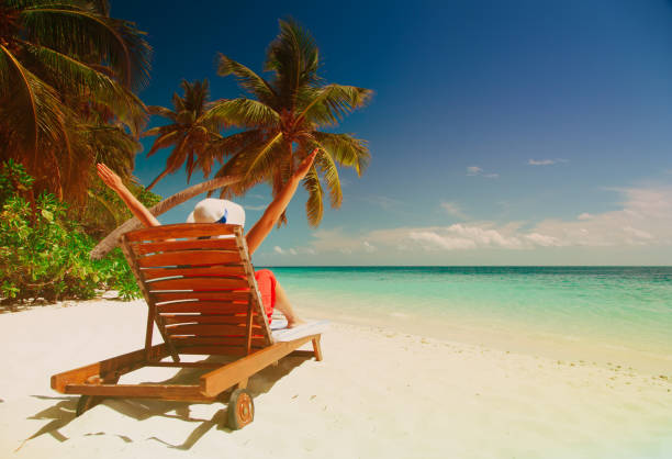 istock happy woman relax on tropical beach 906778520