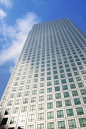 A corner of a modern skyscraper under the blue sky