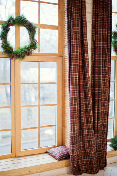 istock Christmas wreath on the window 906780612