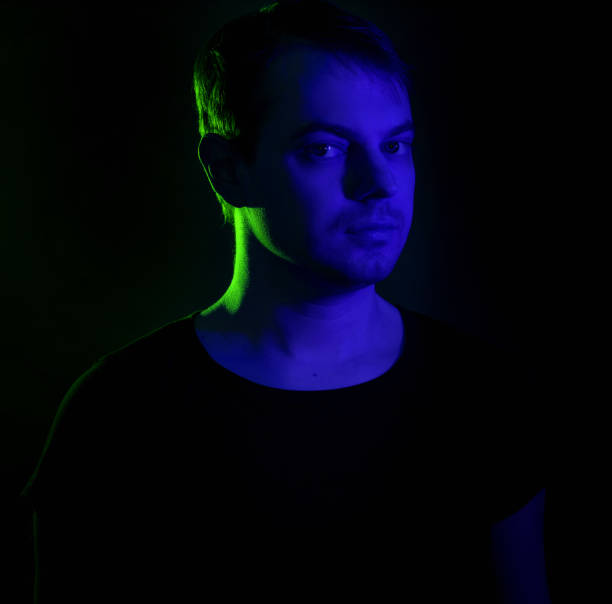 istock Portrait of a man with colored light. 906782750