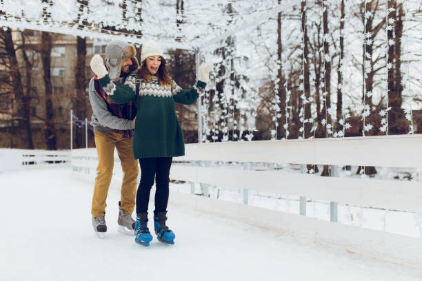 istock Romantic couple skating together in ice rink 906783124
