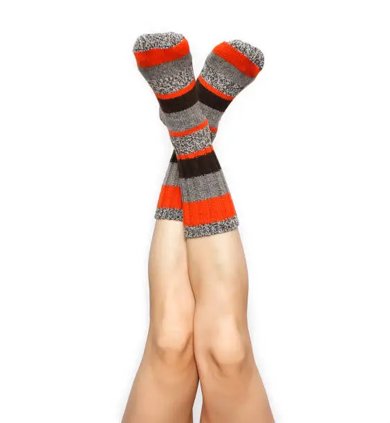 Photo of Female feet in warm socks