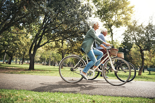 Shot of a senior couple going for a bicycle ride in the park