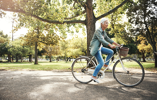 Shot of a senior woman going for a bicycle ride in the park