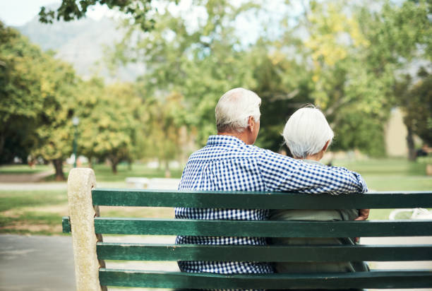 And now it’s time to slow it down Rearview shot of a senior couple relaxing together on a park bench sitting on bench stock pictures, royalty-free photos & images