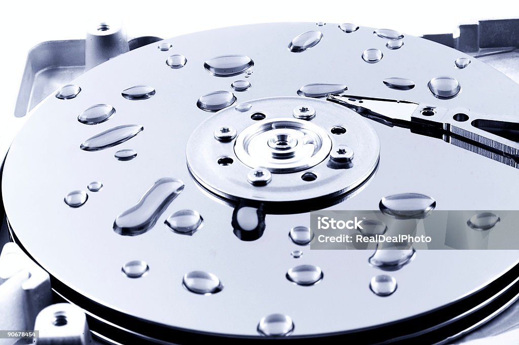 Datta Corruption Droplets of water on the platers of an open hard drive Accessibility Stock Photo