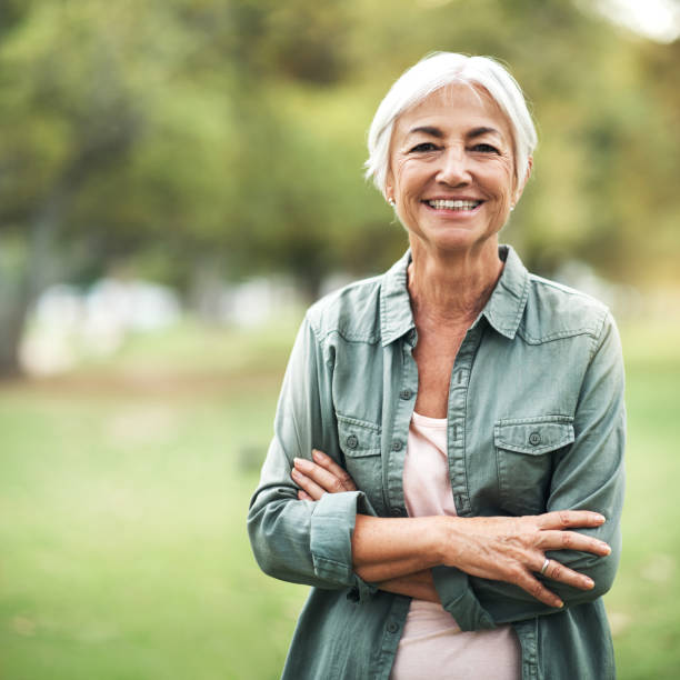 Living life as positively as I can Portrait of a happy and confident senior woman standing in the park 70 79 years stock pictures, royalty-free photos & images