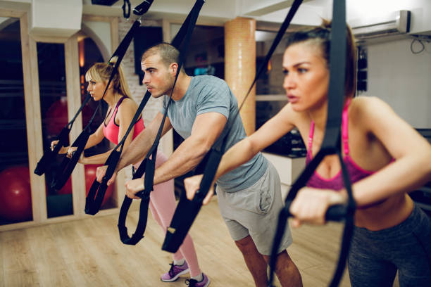 istock TRX suspension training- people doing arm and leg exercises 906788040