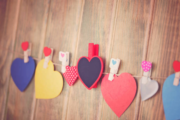 istock Lovely hearts hanging on wooden background. Write your message. 906790298