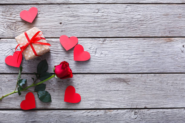 istock Valentine background, handmade hearts, rose and gift on wood 906791416
