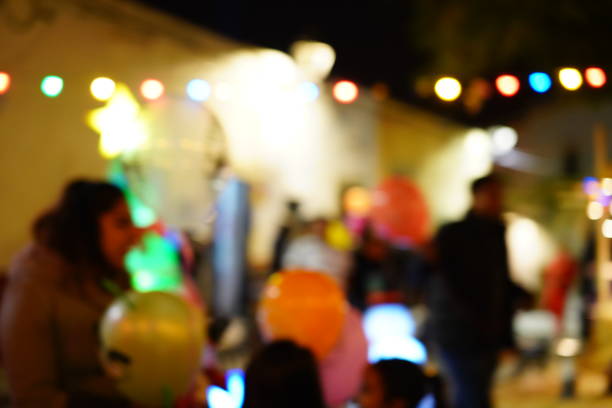 Defocused urban abstract texture bokeh city lights & traffic jams in the background with blurring lights on the top of mountain.