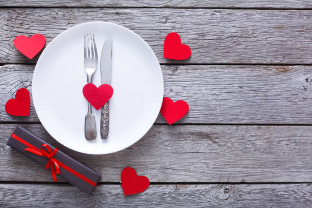 istock Valentine day or proposal background, cutlery on plate on wood 906793992