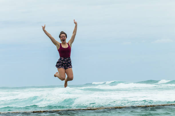 istock Girl Jumping Tidal Pool Wall Ocean 906801430