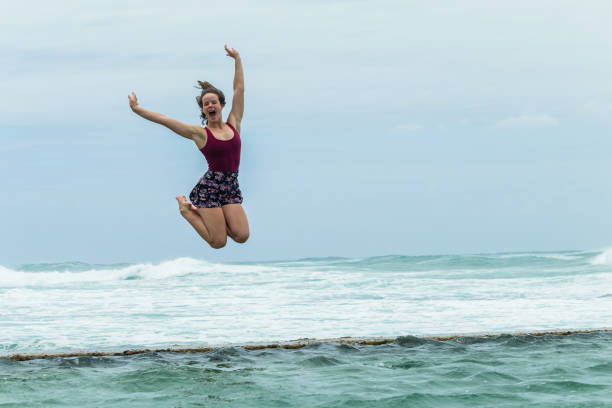 istock Girl Jumping Holidays Pool Ocean 906801800