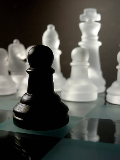 istock Lonely black pawn against all the other white 90680569