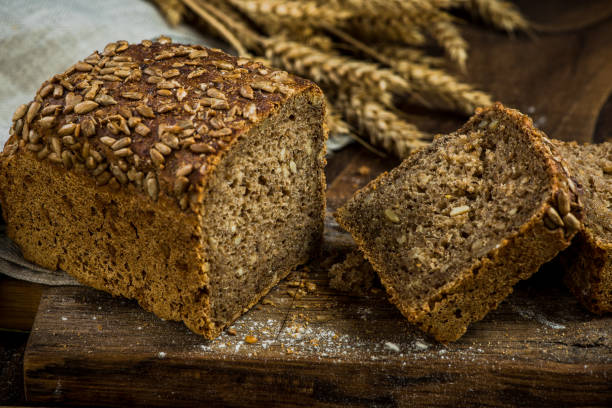 istock Wholegrain bread with seeds sliced on board 906806082