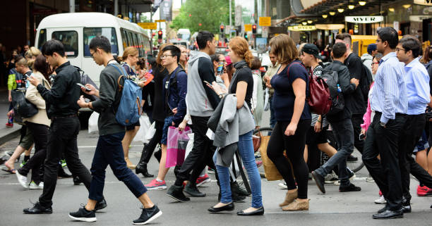 istock People crowd crossing street in central Sydney 906807094