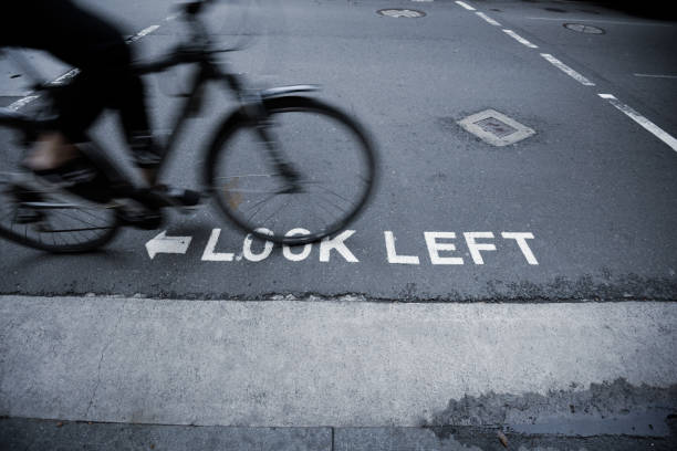 istock Bike in motion, look left road marking 906807224