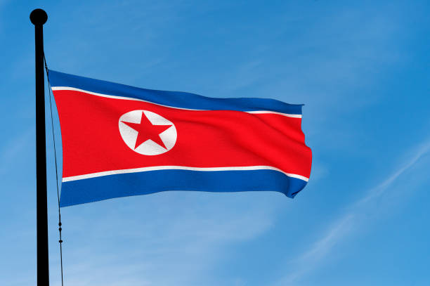 istock North Korean Flag waving over blue sky (3D rendering) 906808220