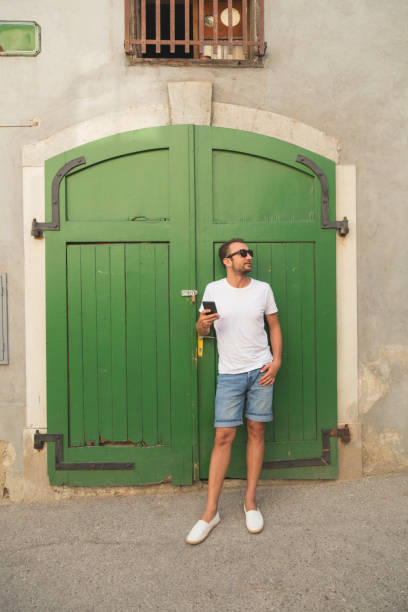 istock Modern guy using cellphone in the European city. 906813430