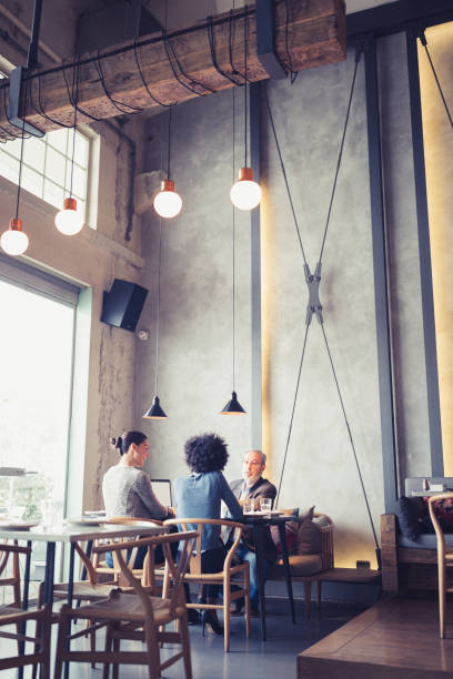 An Authenticated Restaurant, Cafe, Bar View through a Window, Warming Lights, Wooden Concept With Chair and Table, Decorative Lamps