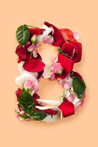 istock Letter B made from red roses and petals isolated on a white background 906819772