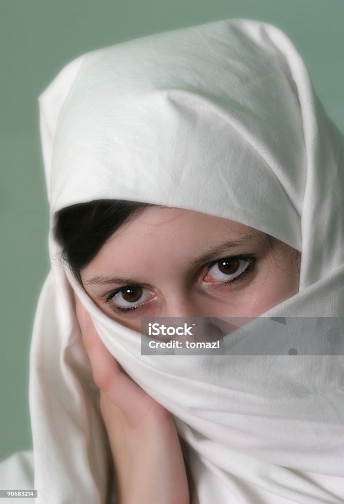 Brown eyes Muslim girl in a white vail with strong brown eyes. Except the eyes the photo is in soft focus. Adult Stock Photo