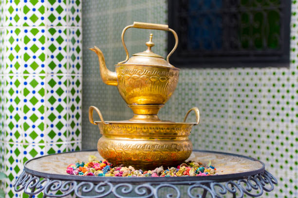 Iron Teapot with the mint tea at a traditional Moroccan house Iron Teapot with the mint tea at a traditional Moroccan house marrakesh riad stock pictures, royalty-free photos & images