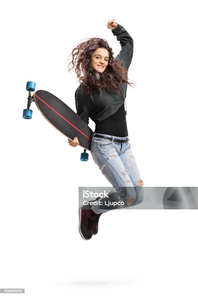 Encantado de chica adolescente con un longboard de salto - Foto de stock de Monopatín - Actividades recreativas libre de derechos