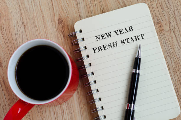 New Year Fresh Start New Year Concept - New year, fresh start text on notepad with pen and a cup of coffee. new year new life stock pictures, royalty-free photos & images