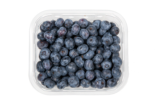 Blueberries in a plastic container cut out and isolated on a white background