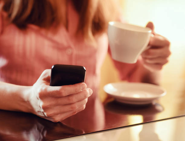 istock Young woman using smartphone in cafe 906835942