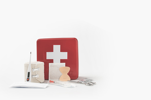 first-aid kit with white cross and medical supplies