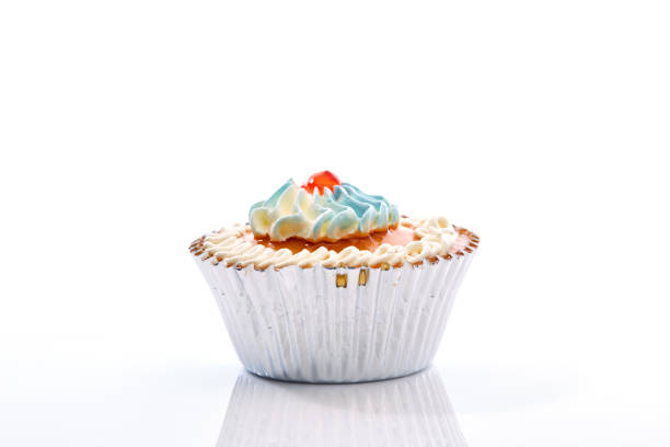 istock An isolated cupcake with sprinkles on a white background 906841386