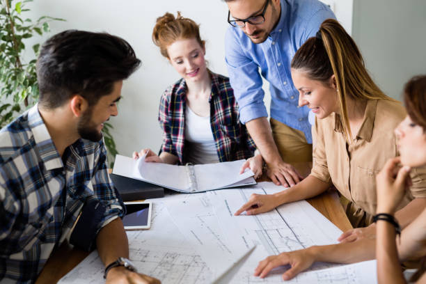 istock Group of architects and designers working and collaborating on project 906844606